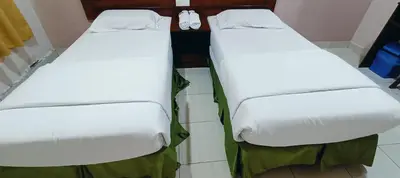 two beds sitting next to each other in a room at Kampar Times Inn Hotel in Kampar