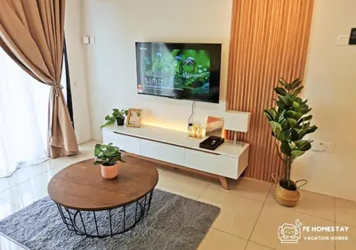 a living room with a tv and a coffee table at FE Cozy Ipoh Homestay Manhattan Condominium Ipoh Waterpark 3BR 8 pax by FE Homestay \u6021\u4fdd\u6c11\u5bbf \u6c34\u4e0a\u4e50\u56ed in Ipoh
