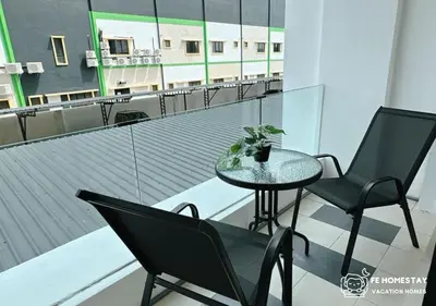a table and two chairs sitting on a balcony at FE Cozy Ipoh Homestay Manhattan Condominium Ipoh Waterpark 3BR 8 pax by FE Homestay \u6021\u4fdd\u6c11\u5bbf \u6c34\u4e0a\u4e50\u56ed in Ipoh