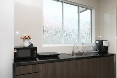 a kitchen with a counter with a sink and a window at Tanjung Bungah 5BR Villa w pool 20pax in Tanjung Bungah