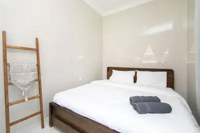 a bedroom with a bed with a gray towel on it at Tanjung Bungah 5BR Villa w pool 20pax in Tanjung Bungah
