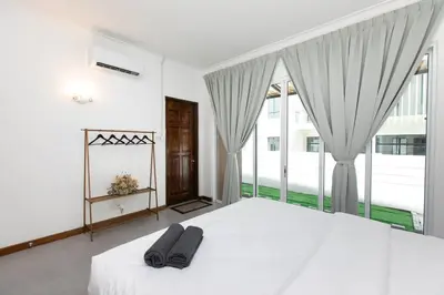 a bedroom with a white bed and a large window at Tanjung Bungah 5BR Villa w pool 20pax in Tanjung Bungah