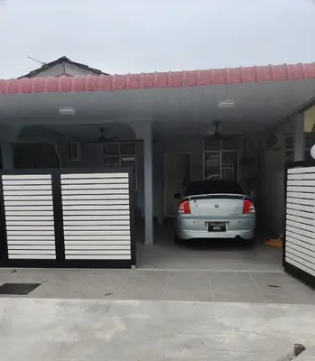 a car parked in a garage with a carport at De Raisha Homestay in Butterworth
