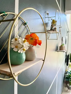 a couple of vases with flowers on a shelf at Aloft Cameron Highlands C in Brinchang