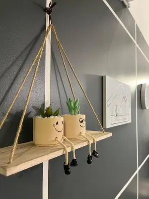 two potted plants on a shelf in a room at Aloft Cameron Highlands C in Brinchang