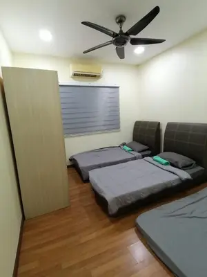 two beds in a room with a ceiling fan at Sekinchan Fragrance \u82ac\u82b3\u6c11\u5bbf in Sekincan