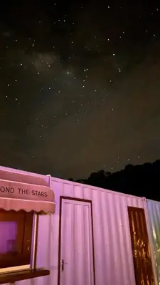 a pink building with a sign that reads around the stars at The Starry Dome Couple Room in Cameron Highlands
