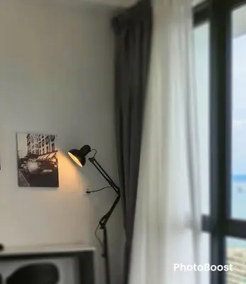 a lamp in a room next to a window at Urban Suites TWO Or THREE Bedroom Georgetown by Annesui Cottage in Jelutong