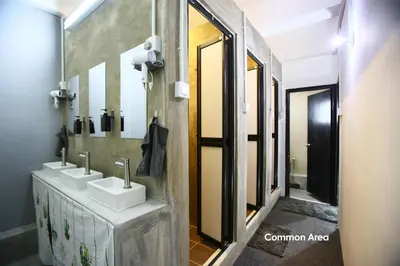 a bathroom with two sinks and a mirror at HangoutSpacez Queensbay at Bayan Lepas Penang in Bayan Lepas