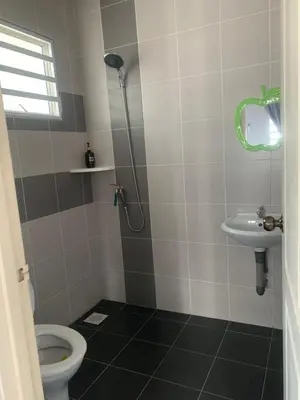 a bathroom with a shower and a toilet and a sink at ADZ Islam Homestay Simpang Pulai in Kampong Kepayang