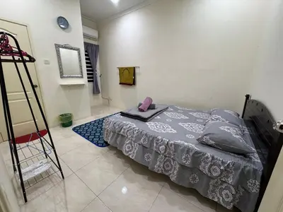 a bedroom with a bed with a phone on it at ADZ Islam Homestay Simpang Pulai in Kampong Kepayang