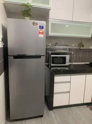 a kitchen with a refrigerator and a microwave at ADZ Islam Homestay Simpang Pulai in Kampong Kepayang