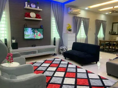 a living room with a couch and a tv at ADZ Islam Homestay Simpang Pulai in Kampong Kepayang