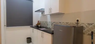 a kitchen with a refrigerator and a sink in it at Anderson Suite by Hopestay Property Management in Ipoh