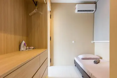 a small room with a bed and a dresser and a bed sqor at Designer Suites 2BR Apartment in Penang near George Town Self Check-In WiFi Partial Seaview in Jelutong