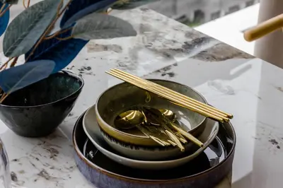 a pile of gold chopsticks sitting on a table at Designer Suites 2BR Apartment in Penang near George Town Self Check-In WiFi Partial Seaview in Jelutong