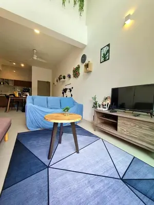 a living room with a blue couch and a table at SweetHome Brinchang Pent House - Pasar Malam area in Brinchang
