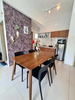 a kitchen and dining room with a wooden table and chairs at SweetHome Brinchang Pent House - Pasar Malam area in Brinchang