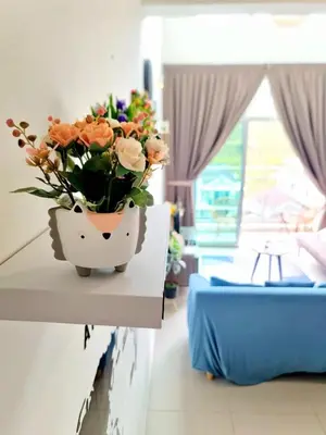 a vase of flowers sitting on a table in a room at SweetHome Brinchang Pent House - Pasar Malam area in Brinchang