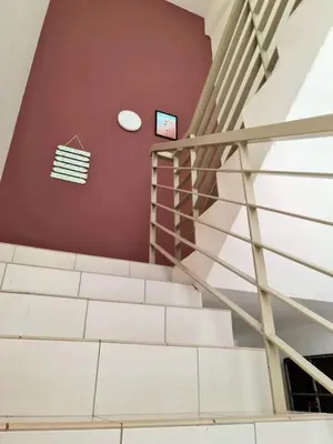 a staircase in a building with a stair case at SweetHome Brinchang Pent House - Pasar Malam area in Brinchang