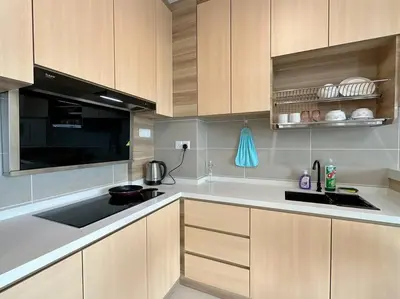a kitchen with a sink and a stove top oven at Sunway Onsen Suite Cozy Homestay in Ipoh