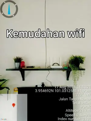 a sign that reads kennelchin with on a wall with plants at Inang Homestay in Teluk Intan