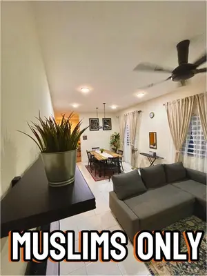a living room with a couch and a ceiling fan at Inang Homestay in Teluk Intan