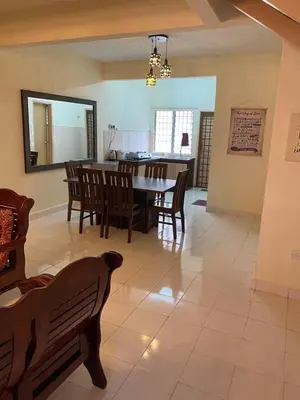 a dining room with a table and chairs at Highlands Double Story House in Tanah Rata