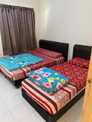 three beds sitting in a room with at Highlands Double Story House in Tanah Rata