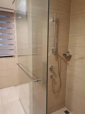 a shower with a glass door in a bathroom at By The Sea Beach Front and Seaview Apartment 2 in Batu Ferringhi