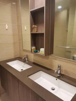 a bathroom with two sinks and a mirror at By The Sea Beach Front and Seaview Apartment 2 in Batu Ferringhi