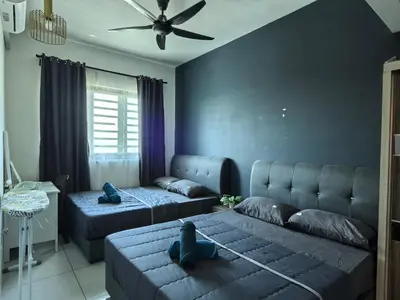 a living room with two beds and a couch at Sweet Homestay Meritus by Moowin in Perai