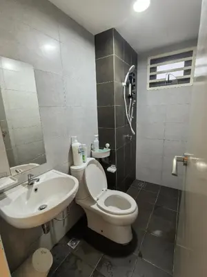 a bathroom with a white toilet and a sink at Sweet Homestay Meritus by Moowin in Perai