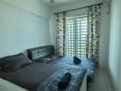 a bed with two pillows on it in a bedroom at Sweet Homestay Meritus by Moowin in Perai