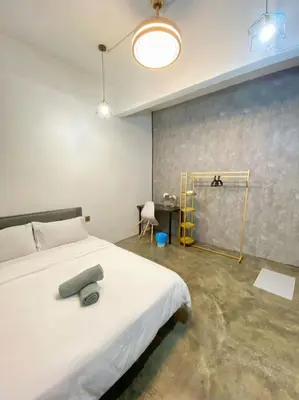 a bedroom with a white bed with a gray pillow on it at Triple Room in King Queen Single Bukit Mertajam Alma in Bukit Mertajam