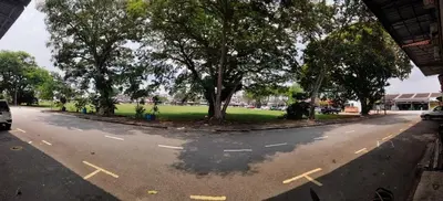 an empty street with trees on the side of the road at Triple Room in King Queen Single Bukit Mertajam Alma in Bukit Mertajam