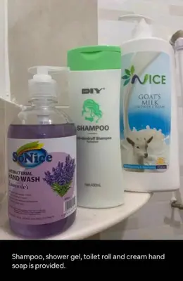 a shelf with bottles of cleaning products on it at Triple Room in King Queen Single Bukit Mertajam Alma in Bukit Mertajam