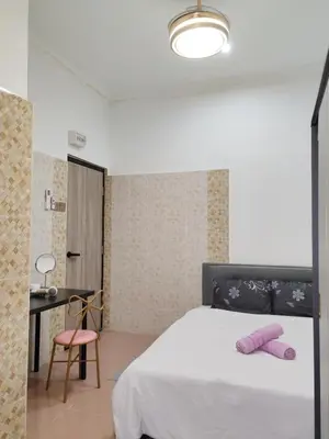 a bedroom with a white bed with pink pillows on it at Pillow Talk 3 Hours Room in Bukit Mertajam