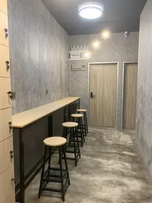 a row of stools in a room with a bar at Pillow Talk 3 Hours Room in Bukit Mertajam