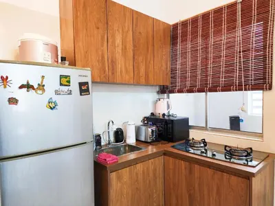 a kitchen with a refrigerator and a sink at Ipoh Apartment Casa Klebang 31200 Chemor Ipoh in Chemor