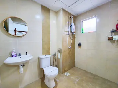 a bathroom with a toilet and a sink and a mirror at Ipoh Apartment Casa Klebang 31200 Chemor Ipoh in Chemor