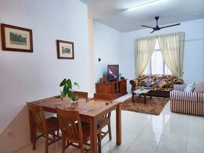 a living room with a wooden table and chairs at Ipoh Apartment Casa Klebang 31200 Chemor Ipoh in Chemor