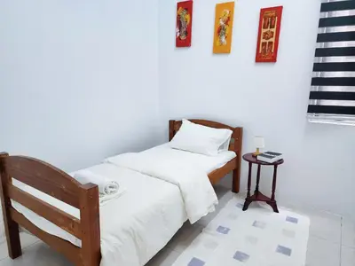 a bedroom with two beds and a side table at Ipoh Apartment Casa Klebang 31200 Chemor Ipoh in Chemor