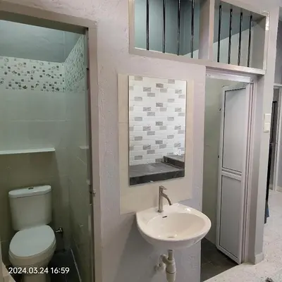 a bathroom with a sink and a toilet at Sterling Homestay in Tanjung Bungah