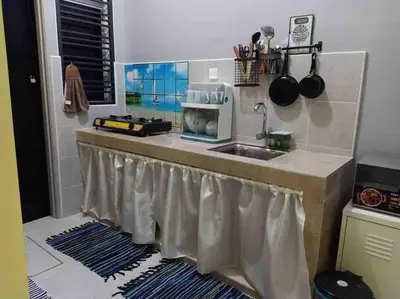 a kitchen with a sink and a counter top at Bota TheDaun Homestay Taman Indera in Kampung Bota Kiri