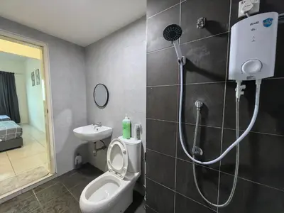 a bathroom with a shower and a toilet and a sink at Meritus Family Comfy Deluxe Home in Perai