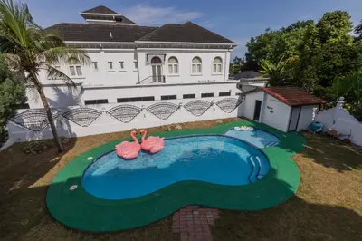 a house with a swimming pool in front of it at Villa55 w Private swimming pool BBQ Pool table 25pax in Bayan Lepas