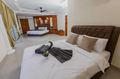 a bedroom with a large bed with towels on it at Villa55 w Private swimming pool BBQ Pool table 25pax in Bayan Lepas