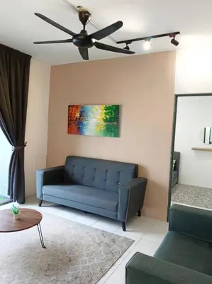 a living room with a blue couch and a ceiling fan at Irdina HomestayMuslim's at Emerald Avenue Brinchang Centrum in Brinchang