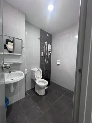 a bathroom with a shower and a toilet and a sink at \u73ed\u53f0\u6c11\u5bbfNo 29 in Pantai Remis